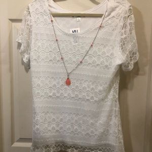 White shirt with coral necklace